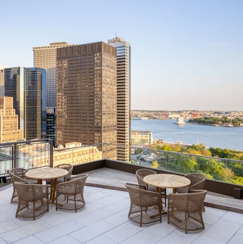 Watch the sun set over the New York Harbour from the roof terrace