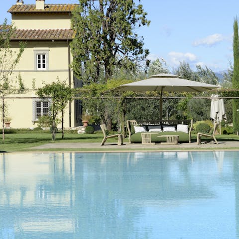 Spend lazy days by the serene poolside at your Tuscan country mansion