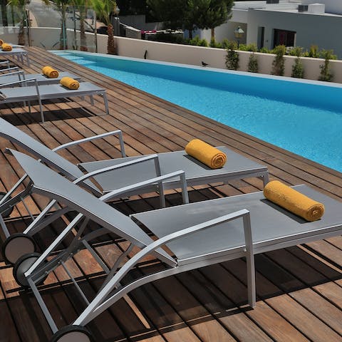 Rest poolside with a cocktail in hand on one of the sun loungers