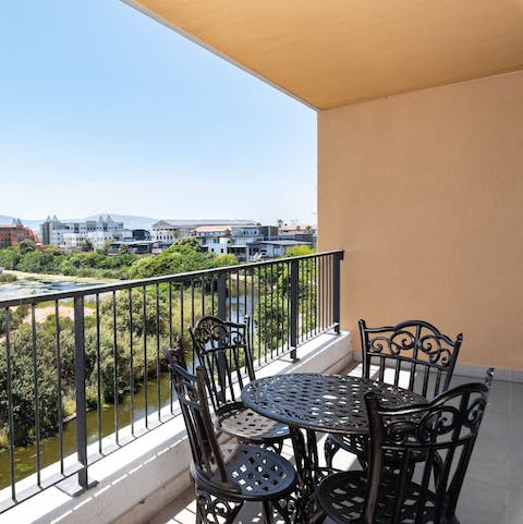 Relax on your balcony with a glass of local wine, overlooking the wetlands and the distant Table Mountain