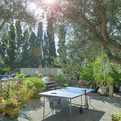 Challenge your friends to a game of table tennis in the lush garden
