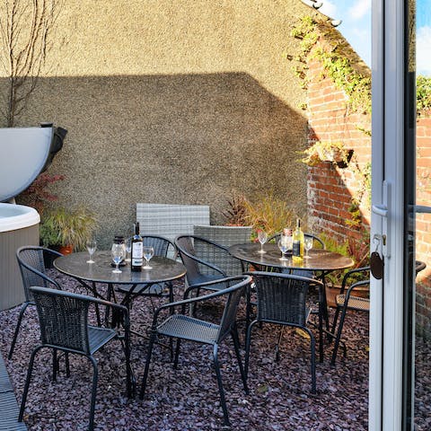 Gather around the outdoor seating area for relaxed barbecue dinners, salads, and wine