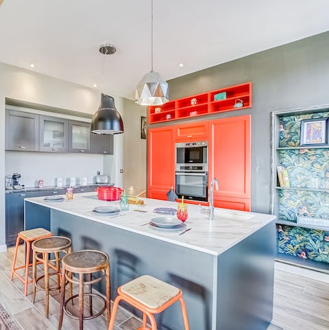 Cook a delicious dinner in your brightly coloured kitchen as loved ones watch on from the island