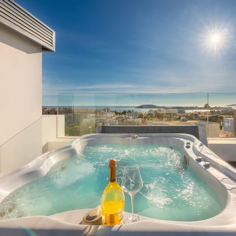 Enjoy a cold glass of vino as you stare out to sea from your private hot tub