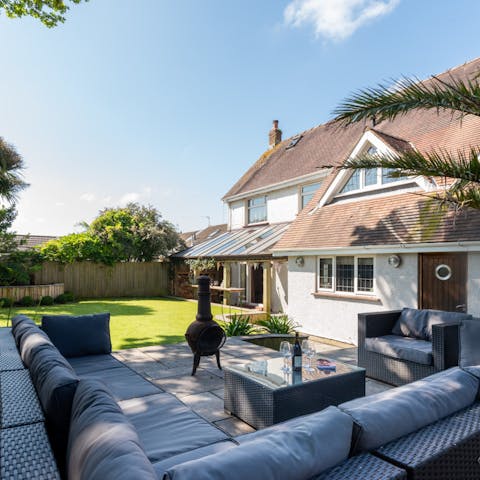 Gather around the fire pit and stretch across the enormous sofa in the outdoor living area 