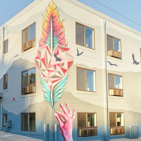 Admire the outside of the building as you arrive – this funky mural is the work of a local artist