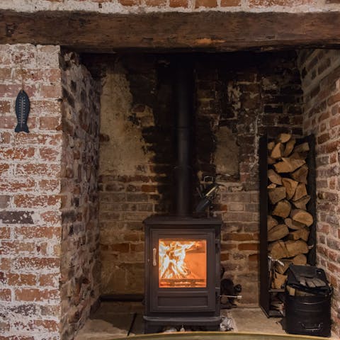 Get cosy by lighting the wood-burning stove for movie night
