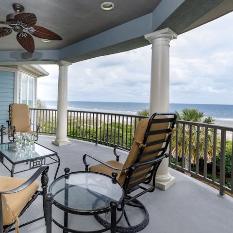 Sip cocktails on this balcony overlooking the beach