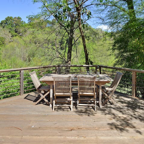 Relax and enjoy your meals alfresco on the large patio overlooking the river 