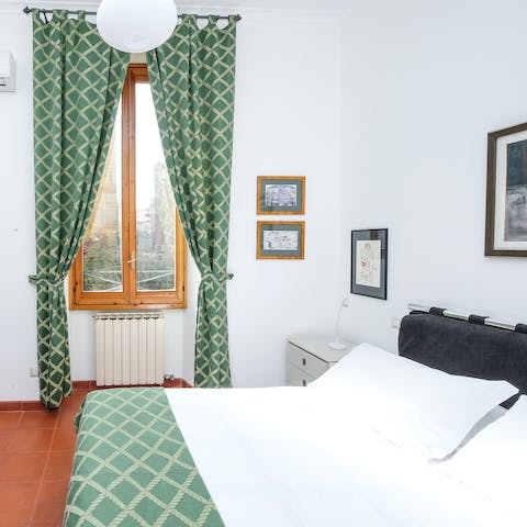 Get cosy in the traditional bedroom after a long day exploring Rome
