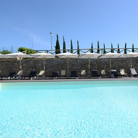 Enjoy a rejuvenating dip in the shared outdoor pool on hot and sunny days