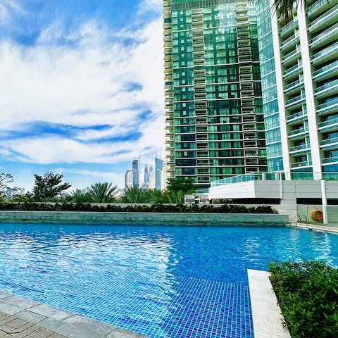 Swim in the communal pool as skyscrapers surround you