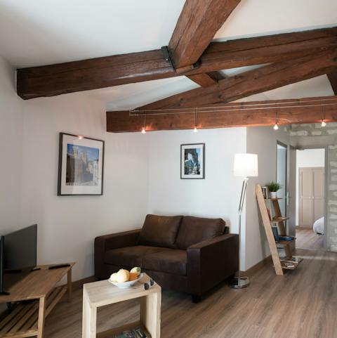 Relax with a good movie under the charming wooden beams 