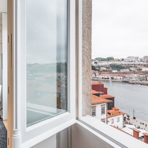 Gaze out at the Douro flowing by from your apartment's window