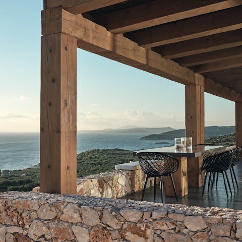 Serve up local wine and olives on the outdoor dining table at sunset