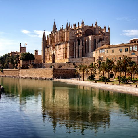 Admire the honey-hued Palma Cathedral, a ten-minute walk from this home