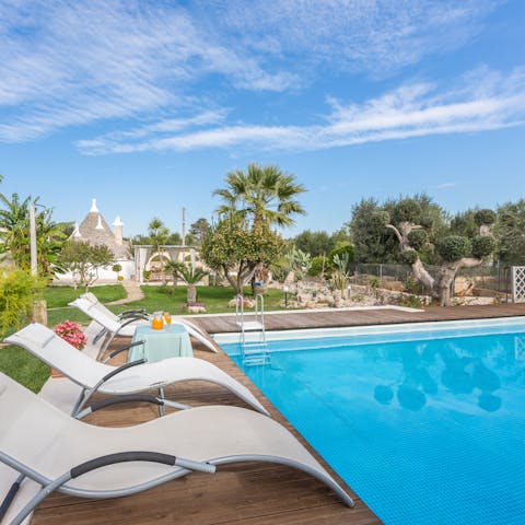 Relax on a poolside lounger with a good book before plunging into the private pool