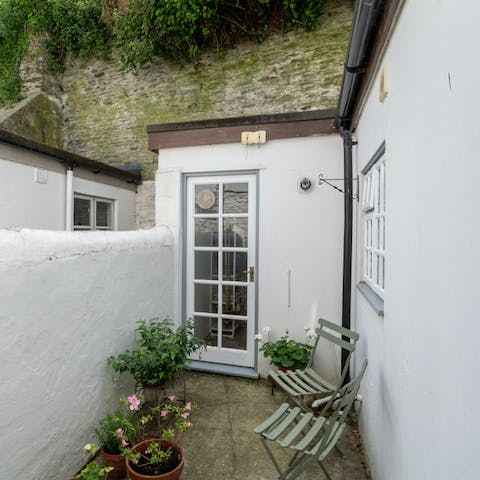 Sit in the courtyard garden with a glass of wine 