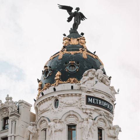 Visit Gran Vía and its majestic Metropolis Building, five minutes away on foot