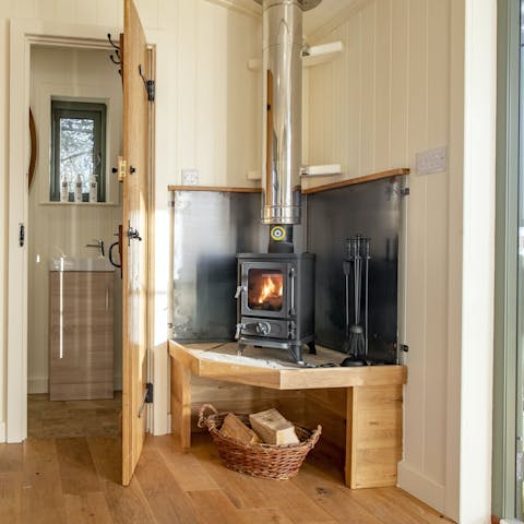 Get cosy by the warmth of the wood-burning stove 