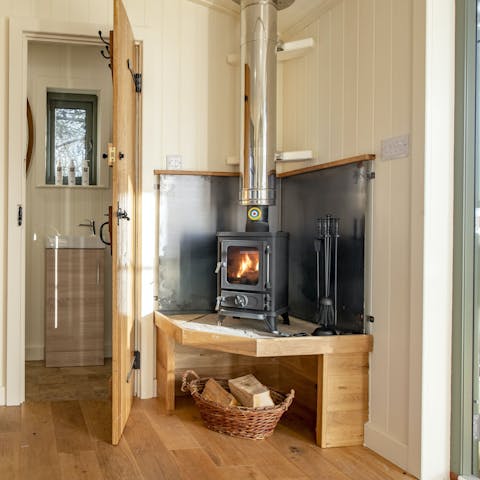 Get cosy by the warmth of the wood-burning stove