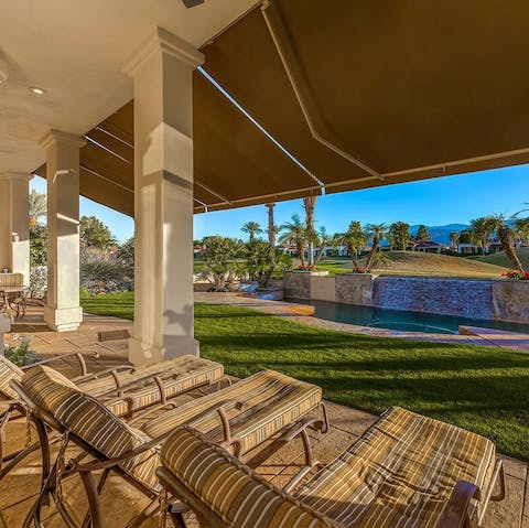 Catch some California sun on the plush day beds under the pergola
