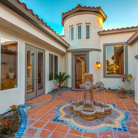 Admire the authentic Spanish features such as the fountain in the tiled courtyard