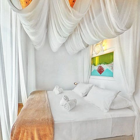 Get a good night's sleep underneath the white canopies in the beach-inspired bedrooms