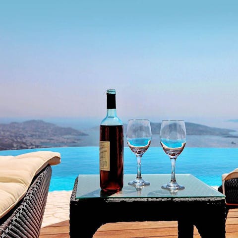 Savour a glass of wine as you watch the incredible Aegean sunset 