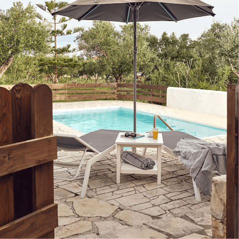 Relax under the parasol after a dip in your private pool
