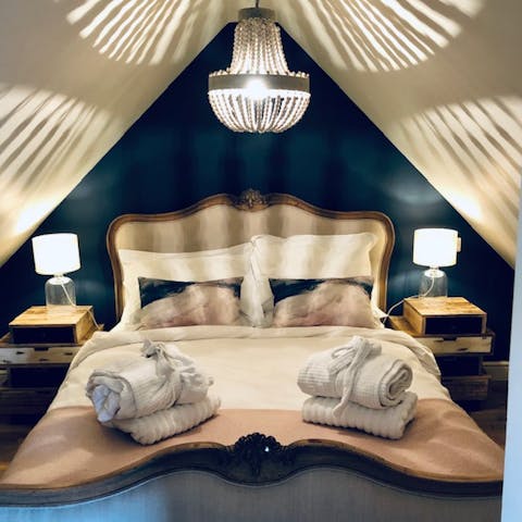 Hunker down in the cosy bedroom underneath the chandelier