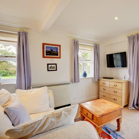 Get snug on the comfortable sofa with beautiful garden and country views