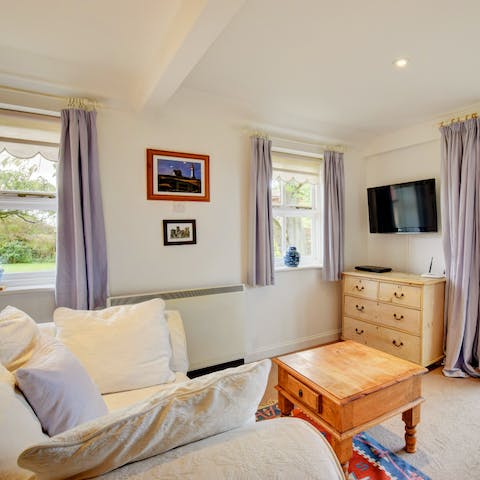 Get snug on the comfortable sofa with beautiful garden and country views