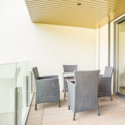 Dine on classy French cuisine around your rattan balcony dining set