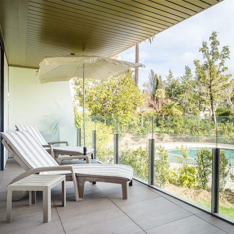 Relax and recline on the balcony sun loungers while enjoying the pool views
