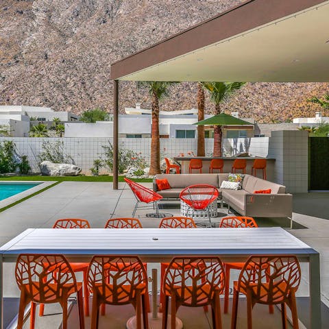 Enjoy meals outside with a selection of dining spots and chic red chairs