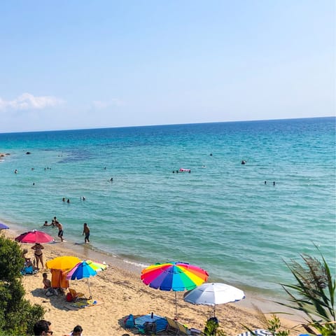 Sink your toes in the sand at Develiki Beach, a ten-minute walk away