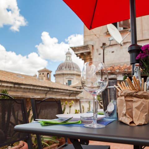Gaze at the domes of ancient Rome from the shared rooftop terrace
