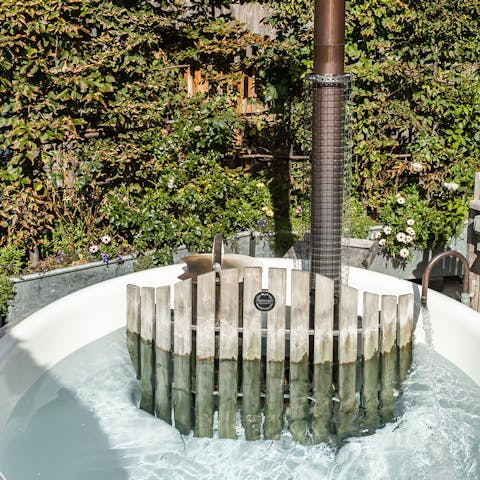 Relax in the wood-fired hot tub with a glass of Champagne
