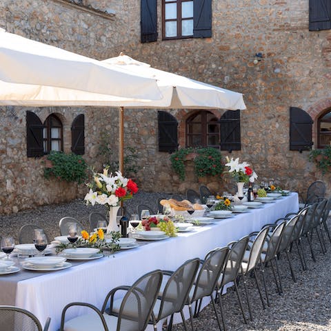 Gather for a celebration meal in the flower-filled courtyard