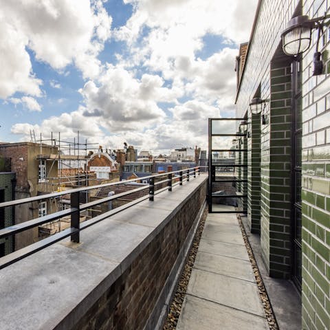Step out onto the private balcony with views over the rooftops of Soho