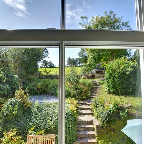Admire the lovely garden and countryside views from the bedrooms