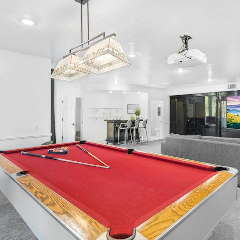 Gather in the recreation room for an evening game of billiards