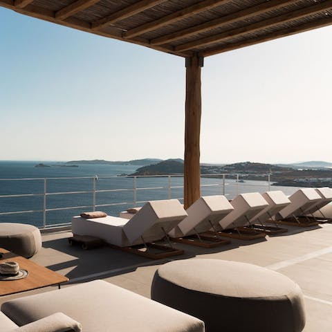 Sip a Mykonos Martini on a sunlounger at sunset