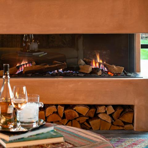 Get toasty and warm by the glass-fronted log-burner fireplace