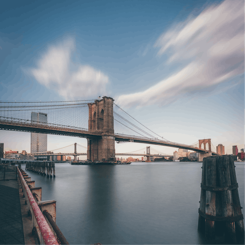 Stroll along Seaport's waterfront, admiring the Brooklyn Bridge view