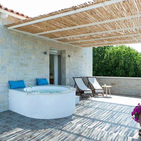 Soak in the hot tub on the covered terrace with a glass of fizz in hand