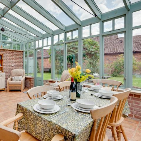 Tuck into some sumptuous dishes on the cute conservatory table 