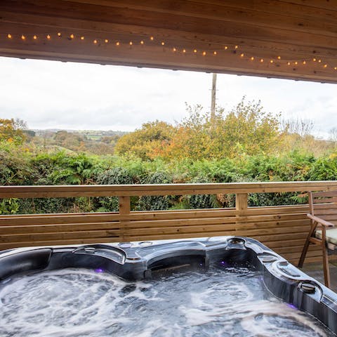 Soak away your cares in the outdoor hot tub out on the covered deck