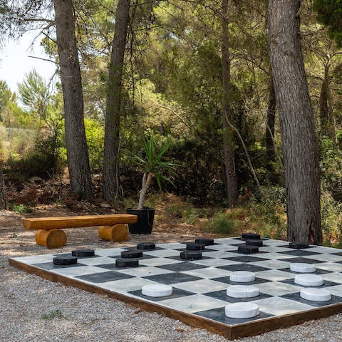 Play draughts under the trees with a glass of Spanish wine in hand